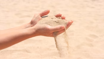 sand-running-through-hands_163782-5024